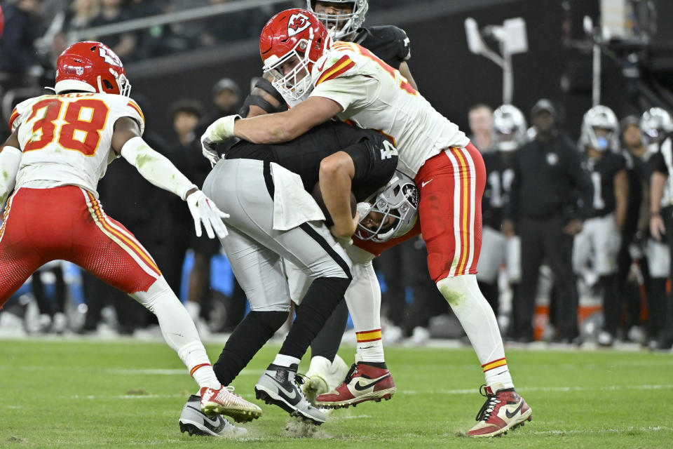 Kansas City Chiefs defensive end George Karlaftis, right, sacks Las Vegas Raiders quarterback Aidan O'Connell during the second half of an NFL football game, Sunday, Nov. 26, 2023, in Las Vegas. (AP Photo/David Becker)