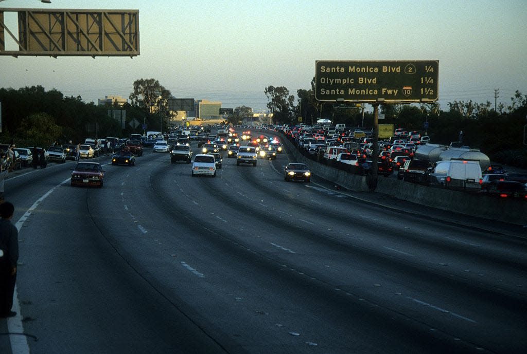 Police cars chase OJ Simpson's white Bronco