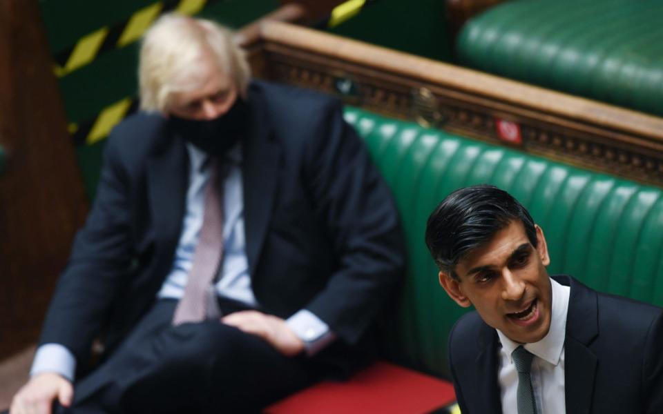 Rishi Sunak delivers his Budget, with Boris Johnson sitting nearby - shutterstock