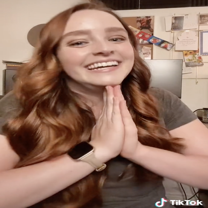 lara using prayer hands while in her video