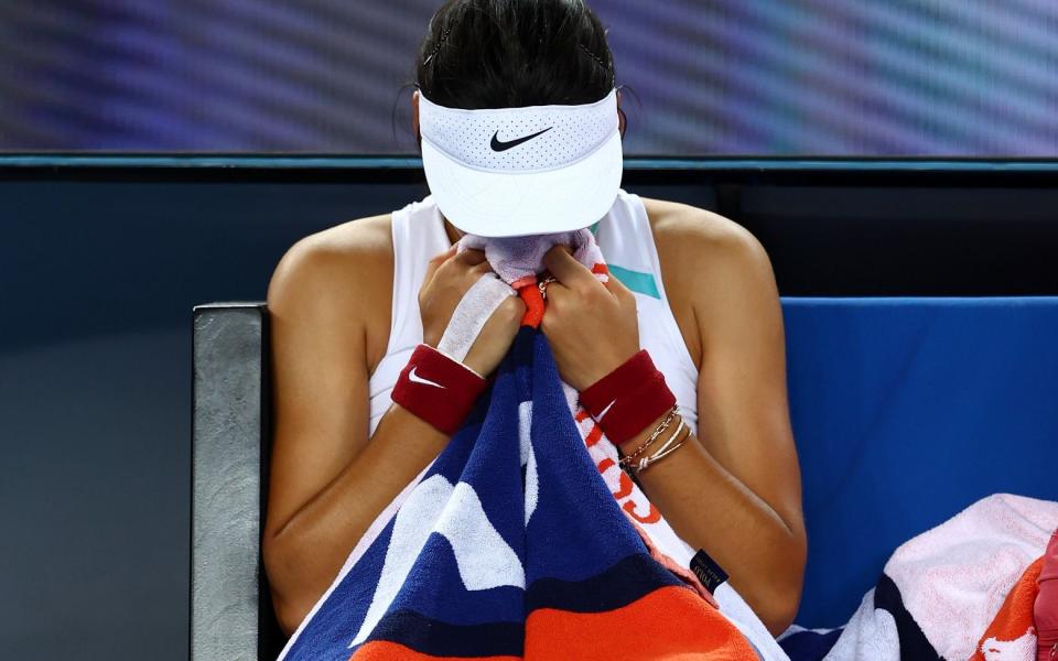 Emma Raducanu buries her face in her towel - GETTY IMAGES