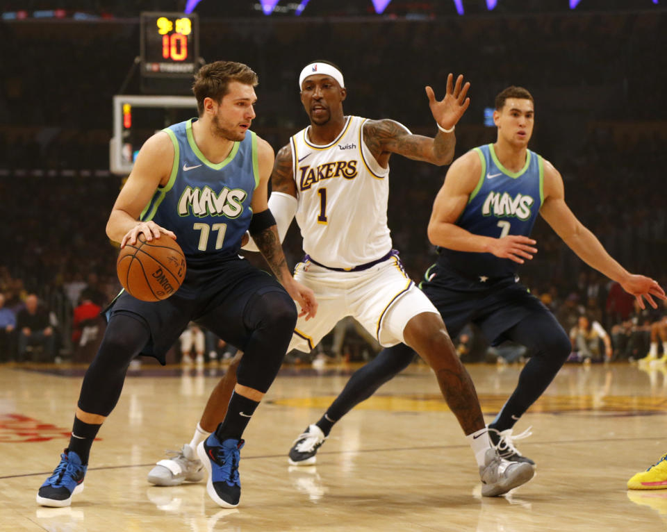 LOS ANGELES, CALIFORNIA - DECEMBER 01:  Luka Doncic #77 of the Dallas Mavericks moves the ball down the court as Kentavious Caldwell-Pope #1 of the Los Angeles Lakers defends during the first half at Staples Center on December 01, 2019 in Los Angeles, California. NOTE TO USER: User expressly acknowledges and agrees that, by downloading and or using this photograph, User is consenting to the terms and conditions of the Getty Images License Agreement. (Photo by Katharine Lotze/Getty Images)