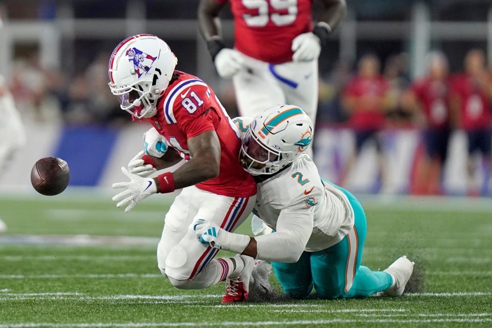 Miami Dolphins linebacker Bradley Chubb, right, strips the ball from the hands of New England Patriots wide receiver Demario Douglas (81) during the first half of an NFL football game, Sunday, Sept. 17, 2023, in Foxborough, Mass. (AP Photo/Steven Senne)