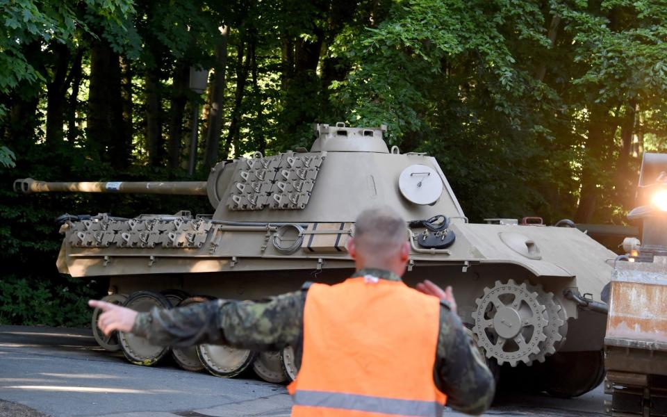 A World War Two era Panther battle tank is made ready for transportation from a residential property in Heikendorf, Germany, 02 July 2015. Since 01 July, police and armed forces are removing recently discovered military equipment from World War II including the 'Panther' tank, weapons and a torpedo. The armoured recovery vehicle is used for safe transportation of weapons. Photo: CARSTEN REHDER/ - Carsten Rehder/B284