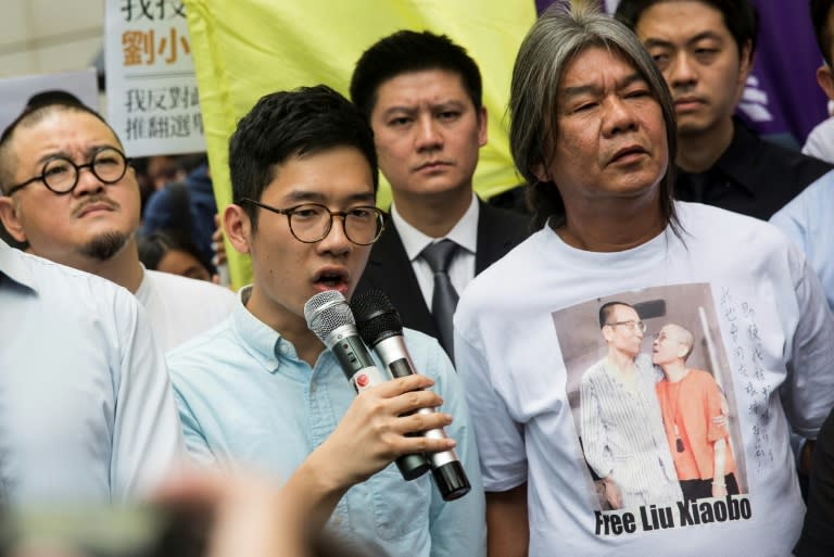 Nathan Law (L) and Leung Kwok-hung, also known as 'Long Hair', (R) were among four Hong Kong lawmakers disqualified for changing their oaths to reflect their frustrations with Chinese authorities