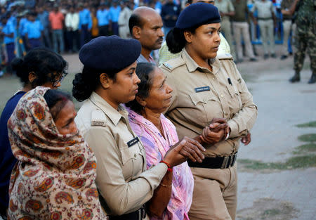 Bonomala Santra (C), mother of Bablu Santra, a Central Reserve Police Force (CRPF) personnel who was killed after a suicide bomber rammed a car into the bus carrying CRPF personnel in south Kashmir on Thursday, is comforted before the cremation of her son at Bauria village in Howrah district in the eastern state of West Bengal, India, February 16, 2019. REUTERS/Rupak De Chowdhuri