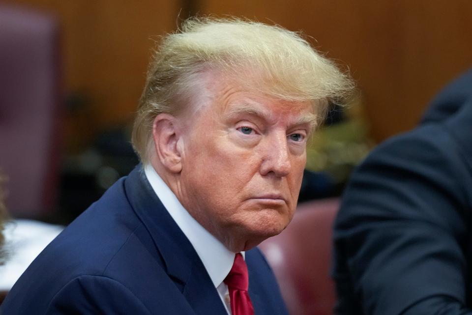 Former President Donald Trump sits at the defense table with his defense team in a Manhattan court, Tuesday, April 4, 2023, in New York. Trump is set to appear in a New York City courtroom on charges related to falsifying business records in a hush money investigation, the first president ever to be charged with a crime.