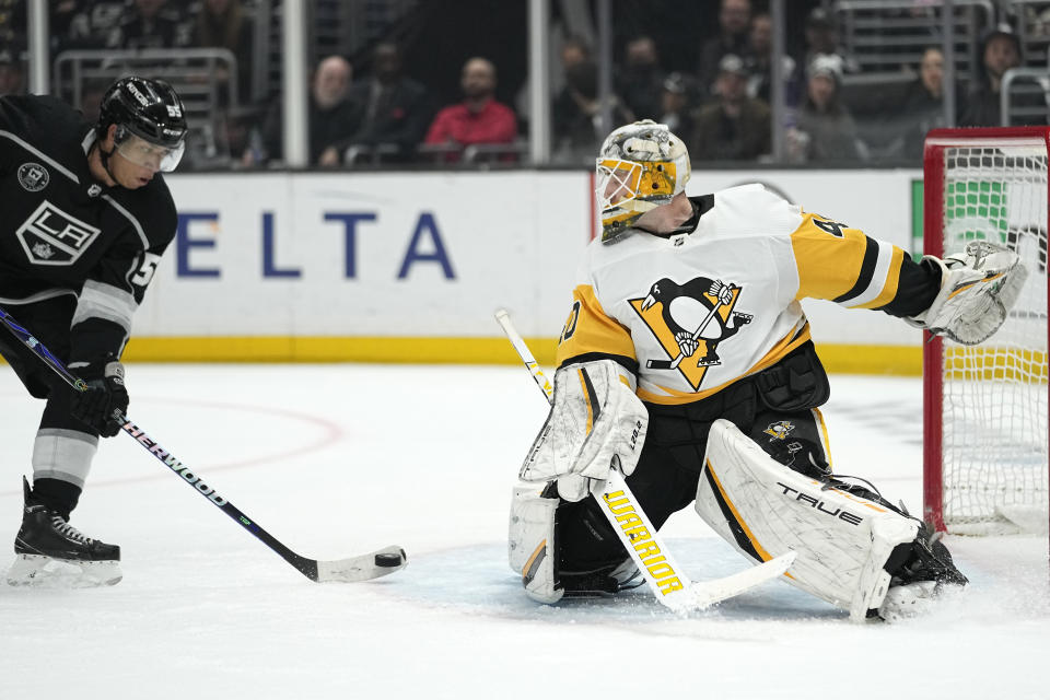Los Angeles Kings center Quinton Byfield, left, tries to score on Pittsburgh Penguins goaltender Dustin Tokarski during the second period of an NHL hockey game Saturday, Feb. 11, 2023, in Los Angeles. (AP Photo/Mark J. Terrill)
