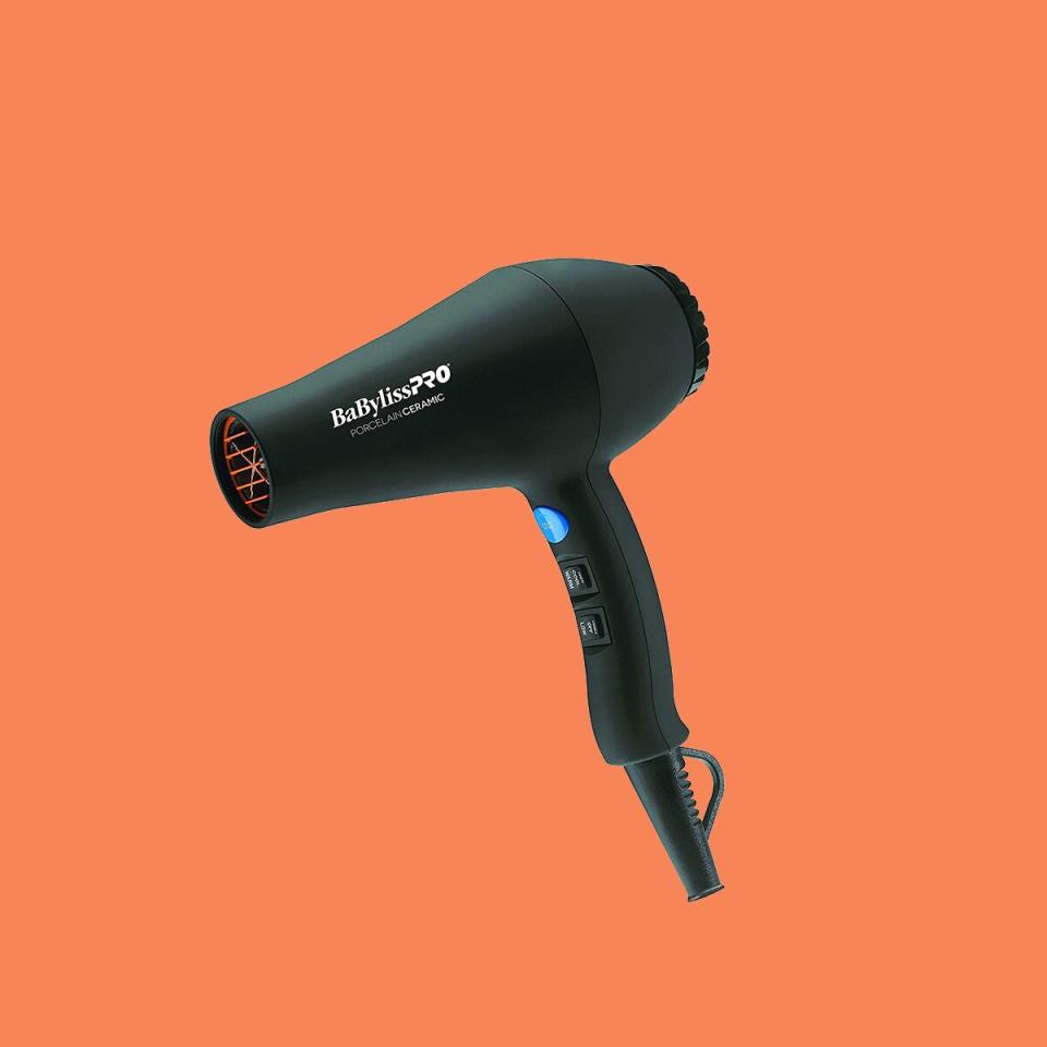 black hair dryer against orange background