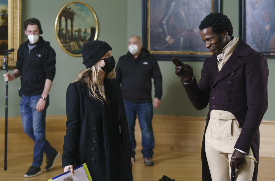 This image released by Bleecker Street shows Ṣọpẹ́ Dìrísù, right, and director Emma Holly Jones on the set of "Mr. Malcolm's List." (Ross Ferguson/Bleecker Street via AP)