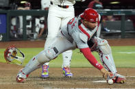 St. Louis Cardinals catcher Willson Contreras goes after a pitch that gets away from him during the seventh inning of the team's baseball game against the Arizona Diamondbacks on Friday, April 12, 2024, in Phoenix. The Cardinals won 9-6. (AP Photo/Ross D. Franklin)