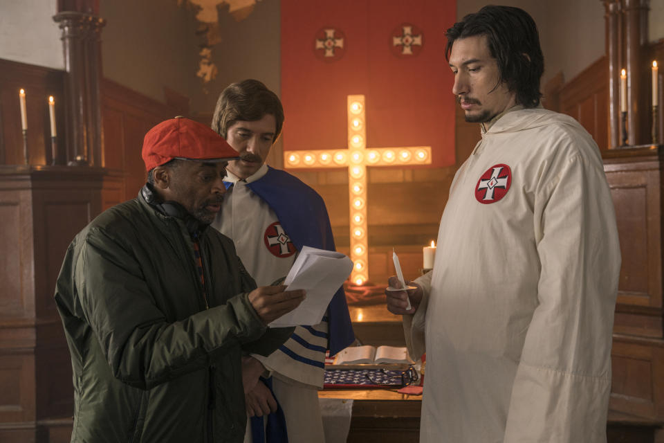 This image released by Focus Features shows director Spike Lee, left, with actors Topher Grace, center, and Adam Driver on the set of Lee’s film “BlacKkKlansman.” (David Lee/Focus Features via AP)