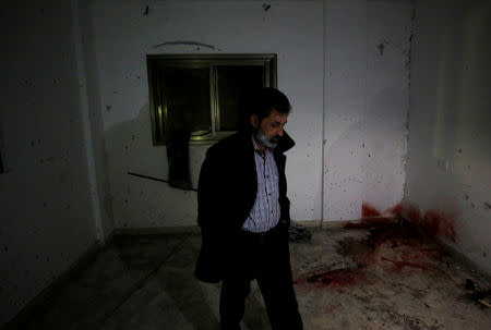 A man walks in a damaged house where a Palestinian gunman was killed by Israeli forces, near Nablus in the Israeli-occupied West Bank December 13, 2018. REUTERS/Abed Omar Qusini