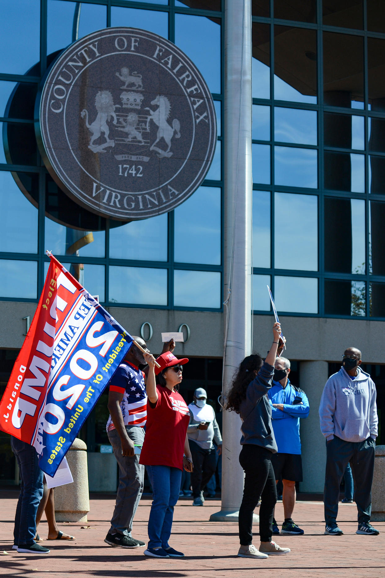 Trump supporters chant, “Four more years,” on Sept. 19 outside the Fairfax County Government Center in Fairfax, Va., disrupting early voting