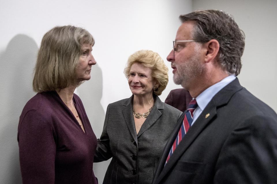 Sen. Gary Peters., right, Sen. Debbie Stabenow, D-Mich., center, and Elizabeth Whelan, the sister of Paul Whelan, left, speak following a news conference to call on Congress to pass a resolution condemning the Russian government for detaining Paul Whelan, on Capitol Hill, Thursday, Sept. 12, 2019, in Washington. (AP Photo/Andrew Harnik)