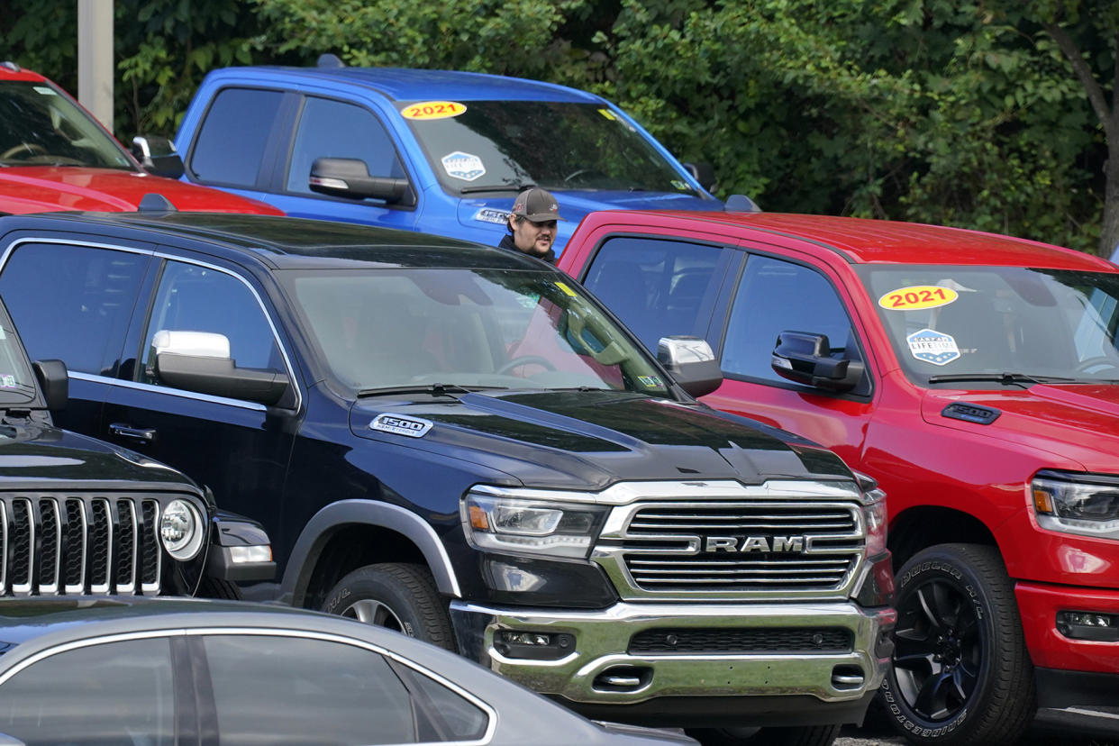 File - A man walks through a used car lot in Pittsburgh on Thursday, Sept. 29, 2022. On Thursday, the Labor Department reports on U.S. consumer prices for December. (AP Photo/Gene J. Puskar, File)