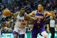 Charlotte Hornets guard Dwayne Bacon drives on Phoenix Suns forward Elie Okobo (2) during the first half of an NBA basketball game Sunday, Jan. 12, 2020, in Phoenix. (AP Photo/Rick Scuteri)