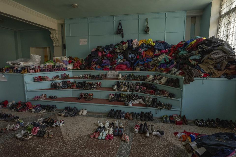 Clothes and shoes on display to be distributed to people, at the humanitarian aid headquarters, in Kramatorsk, Ukraine, Tuesday, July 5, 2022. (AP Photo/Nariman El-Mofty)