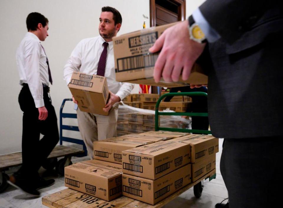 Staff members load boxes of Hershey’s candy on to pallets outside of office of Senator Pat Toomey, who is in charge of Senate candy.