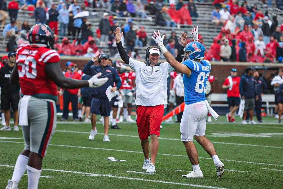 Mississippi coach Lane Kiffin celebrates after his team scores a touchdown during its spring game.
