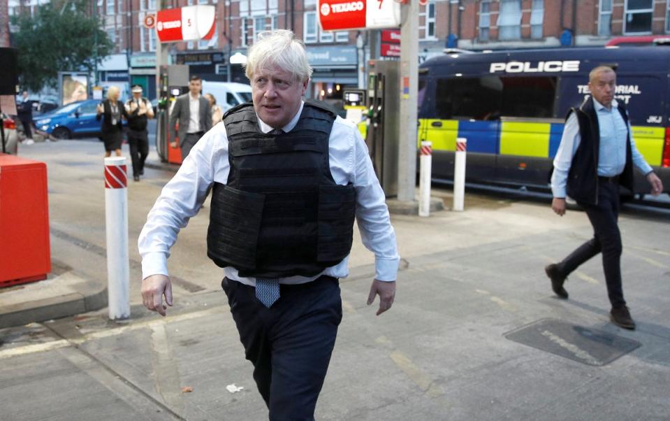 Mr Johnson leaves a drugs-related raid by Metropolitan Police officers (Peter Nicholls/PA) (PA Wire)