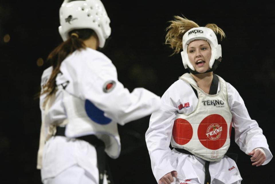 <div class="inline-image__caption"><p>Kay Poe competes during the Titan Games in February 2003.</p></div> <div class="inline-image__credit">Jed Jacobsohn\Getty</div>