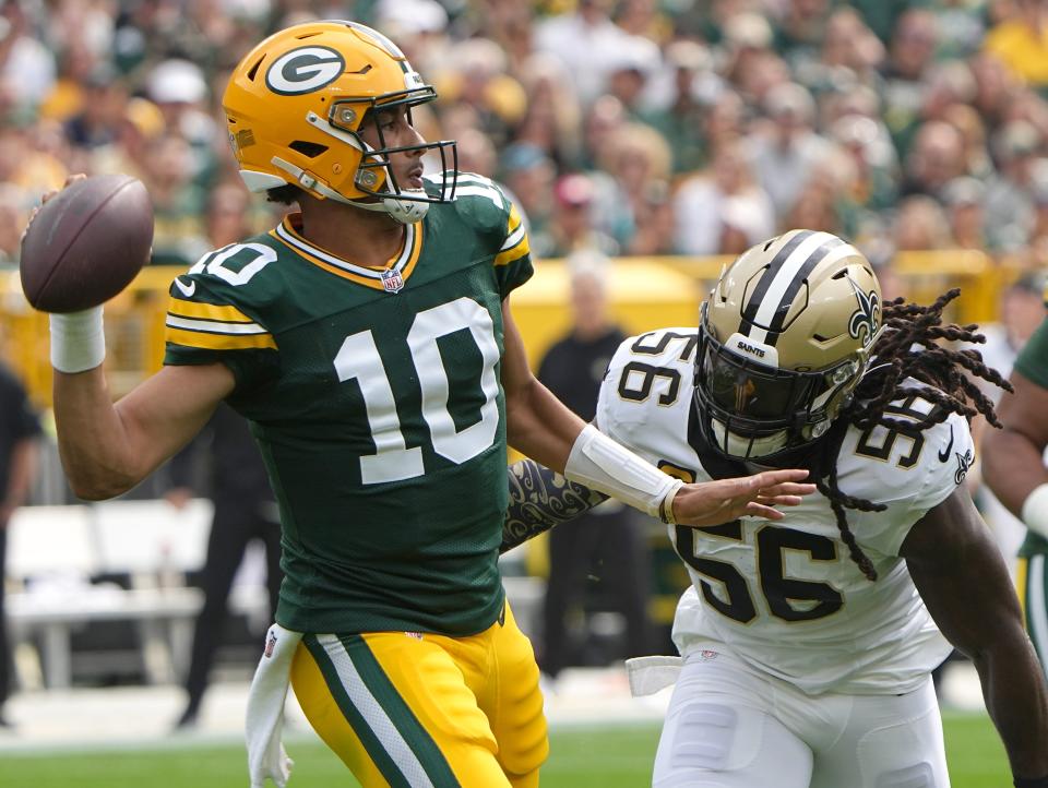 Green Bay Packers quarterback Jordan Love is pressured by New Orleans Saints linebacker Demario Davis during the first quarter Sunday, September 24, 2023, at Lambeau Field in Green Bay, Wis.