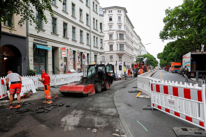 Workers build bicycle lanes, in Berlin