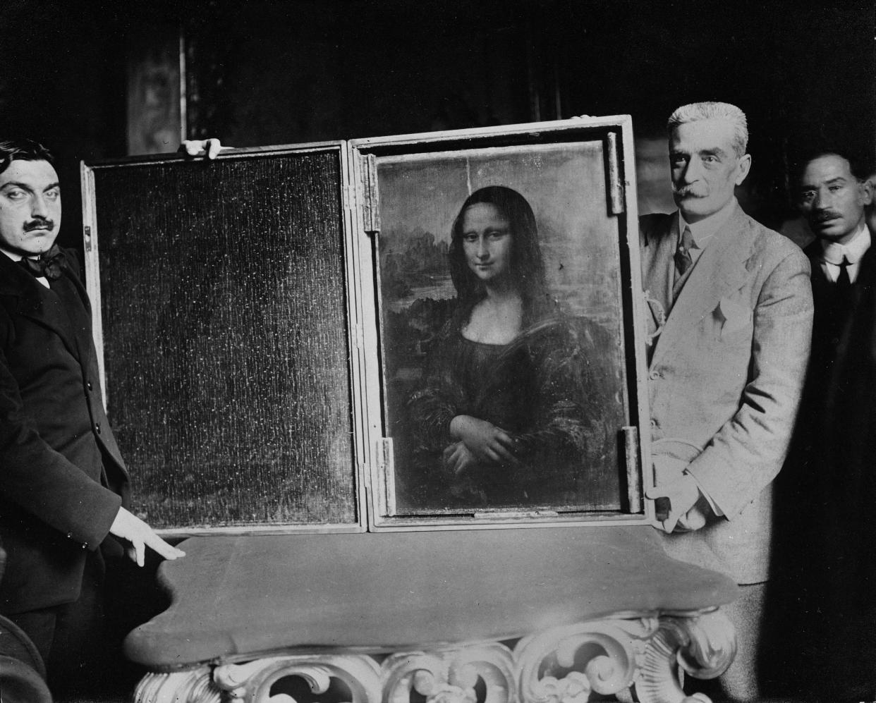 PARIS – 1914: Two men carry the painting of the Mona Lisa back to the Louvre Museum in Paris, France. Vincenzo Peruggia committed the biggest art theft of the 20th century. (Photo by Roger-Viollet/Getty Images)