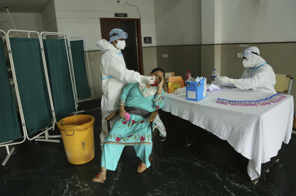 A health worker collects a nasal swab sample to test for COVID-19 at a government hospital in Jammu, India, Tuesday, Sept. 15, 2020. India confirmed more than 83,000 new coronavirus cases on Tuesday, bringing its total caseload to nearly 5 million. (AP Photo/Channi Anand)