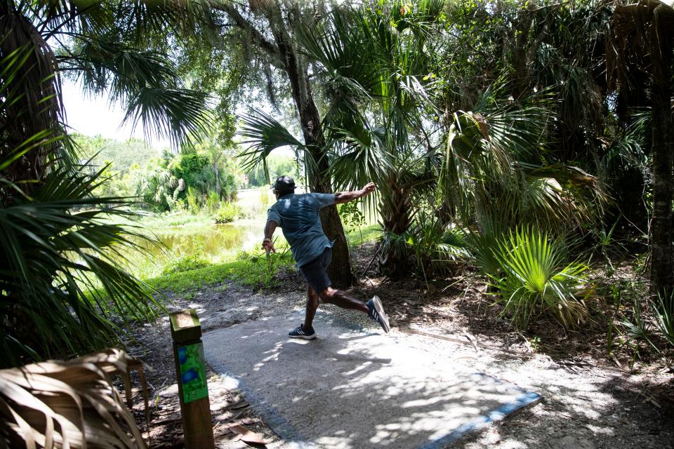 Moe Stewart plays a round of disc golf at Estero Community Park. Temps at the park were in the mid to upper 90’s.