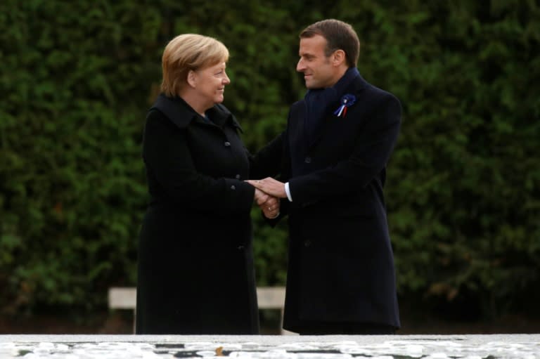 French President Emmanuel Macron and German Chancellor Angela Merkel shakes hands after unveiling a plaque in a French-German ceremony in the clearing of Rethondes (the Glade of the Armistice) in Compiegne, northern France, on November 10, 2018 as part of commemorations marking the 100th anniversary of the 11 November 1918 armistice, ending World War I