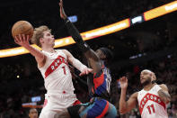 Toronto Raptors guard Gradey Dick (1) drives to the net as Brooklyn Nets guard Dennis Schroder (17) defends while Raptors' Bruce Brown (11) looks on during the first half of an NBA basketball game in Toronto, Monday, March 25, 2024. (Nathan Denette/The Canadian Press via AP)