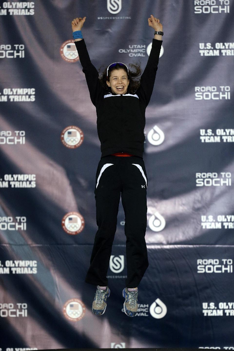 Maria Lamb leaps on the podium after the women's 5,000 meters during the U.S. Olympic speedskating trials Wednesday, Jan. 1, 2014, in Kearns, Utah. (AP Photo/Rick Bowmer)