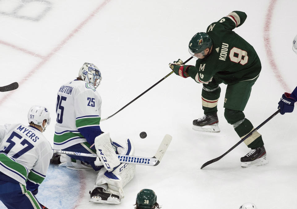 Minnesota Wild's Mikko Koivu (9) is stopped by Vancouver Canucks goalie Jacob Markstrom (25) during the first period of an NHL hockey playoff game Friday, Aug. 7, 2020, in Edmonton, Alberta. (Jason Franson/Canadian Press via AP)