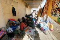 Ethiopians sit with their belongings in Hamdait village on the Sudan-Ethiopia border in eastern Kassala state