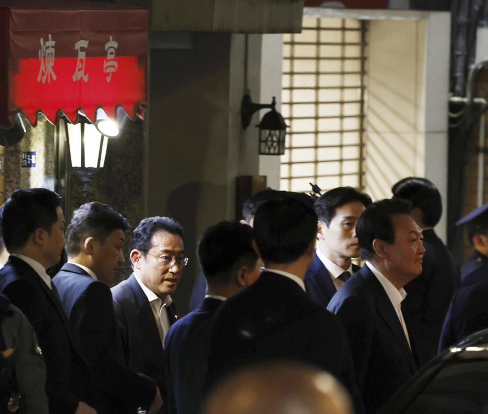 South Korean President Yoon Suk Yeol, right, and Japanese Prime Minister Fumio Kishida, third left, leave a restaurant in Tokyo, Japan, Thursday, March 16, 2023. (Takuto Kaneko/Kyodo News via AP)