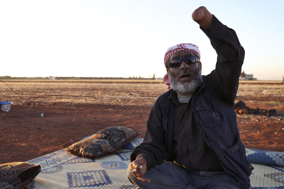 Ali Mansour, 43, who lost his eyes and hands to a cluster bomb in 2019, holds up his arm at a camp in Idlib province, Syria, on July 19, 2023. More than 300 people were killed by cluster munitions in Ukraine in 2022, according to an international watchdog, displacing Syria as the country with the highest number of deaths from the controversial weapons for the first time in a decade. (AP Photo/Omar Albam)