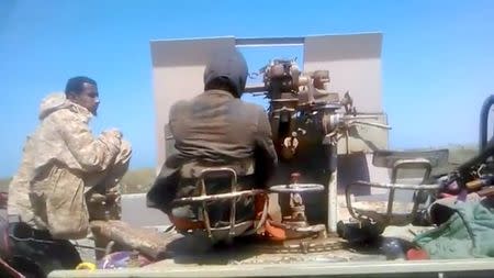 Members of UAE-backed fighters, Yemeni Resistance Giants' Brigade sit with the gun at the back of truck, near airport on the outskirts of Hodeidah, Yemen, June 19, 2018 in this still image taken from video. YEMENI RESISTANCE GIANTS' BRIGADE/REUTERS