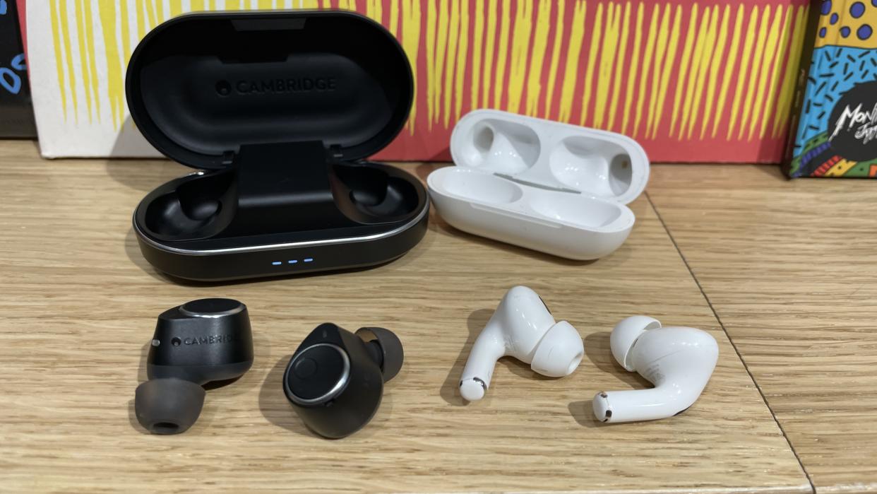  Cambridge Audio Melomania M100 vs Apple AirPods Pro 2 earbuds with their charging cases. 