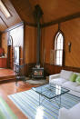 <p>Here’s the cozy den with a wood-burning fireplace. </p>