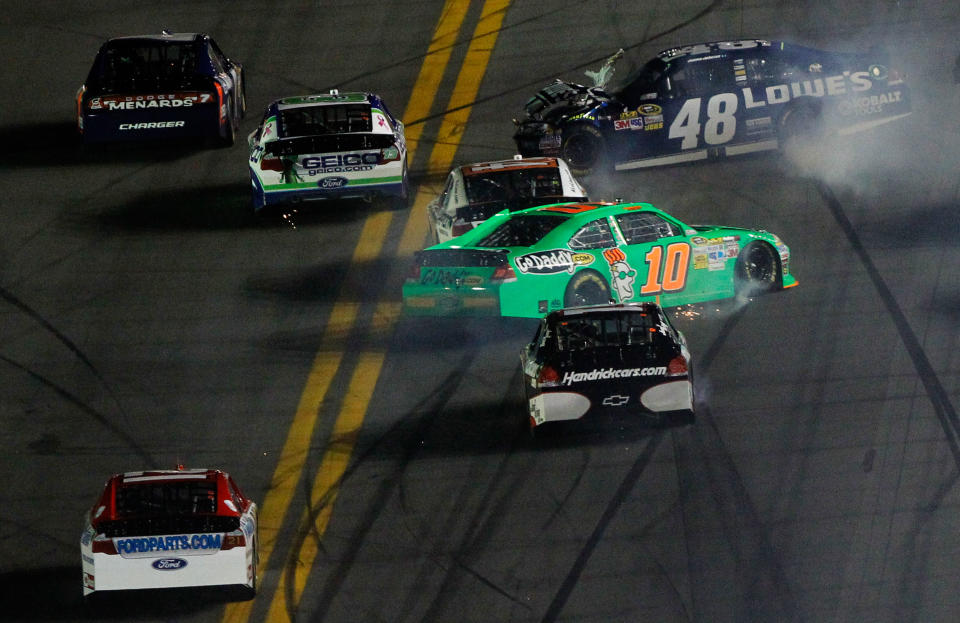 DAYTONA BEACH, FL - FEBRUARY 27: Danica Patrick, driver of the #10 GoDaddy.com Chevrolet, and Jimmie Johnson, driver of the #48 Lowe's Chevrolet, spin after being involved in an on track incident during the NASCAR Sprint Cup Series Daytona 500 at Daytona International Speedway on February 27, 2012 in Daytona Beach, Florida. (Photo by Tom Pennington/Getty Images for NASCAR)