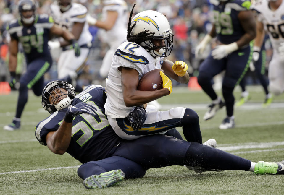 Seattle Seahawks' K.J. Wright (50) tackles Los Angeles Chargers' Travis Benjamin during the second half of an NFL football game, Sunday, Nov. 4, 2018, in Seattle. (AP Photo/Ted S. Warren)