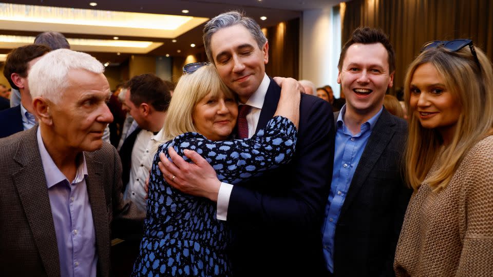 Simon Harris embraces his family after being announced as the new leader of Fine Gael. - Clodagh Kilcoyne/Reuters
