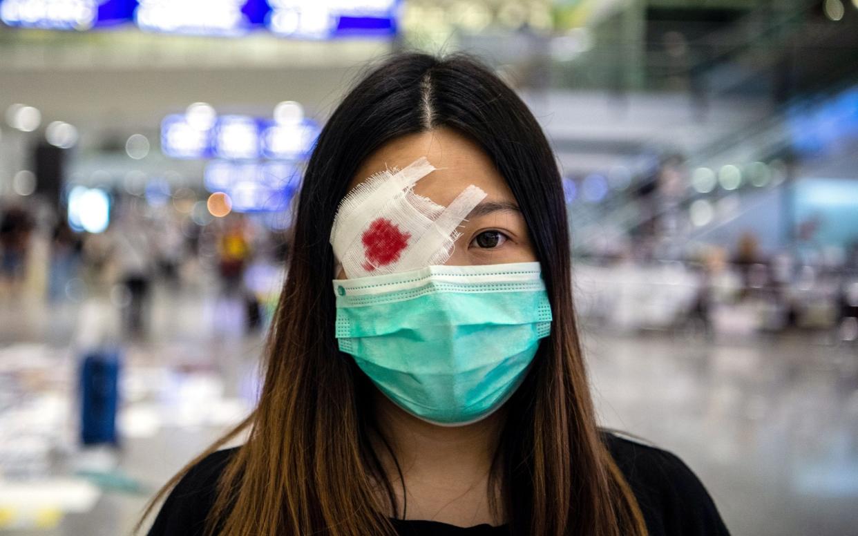 A protester wears a mock eye patch during the occupation of Hong Kong International Airport - REX