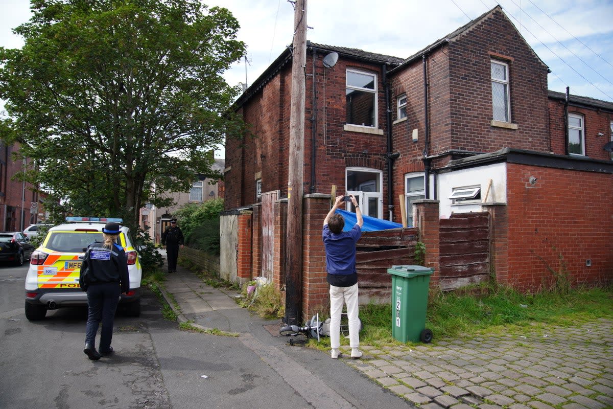 Police officers outside his property on Ainsworth Road (Peter Byrne/PA Wire)