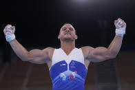 Samir Ait Said, of France, celebrates after performing on the rings during the men's artistic gymnastic qualifications at the 2020 Summer Olympics, Saturday, July 24, 2021, in Tokyo. (AP Photo/Gregory Bull)