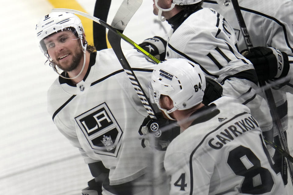 Los Angeles Kings' Adrian Kempe, left, celebrates after scoring his second goal of the third period during an NHL hockey game against the Pittsburgh Penguins in Pittsburgh, Sunday, Feb. 18, 2024. (AP Photo/Gene J. Puskar)