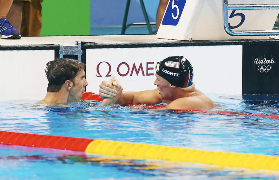 Phelps makes history, again, as the first swimmer to repeat gold in the same event in four consecutive Olympics. Lochte finished fifth, but congratulated Phelps. (Credit: Xavier Laine/Getty Images)