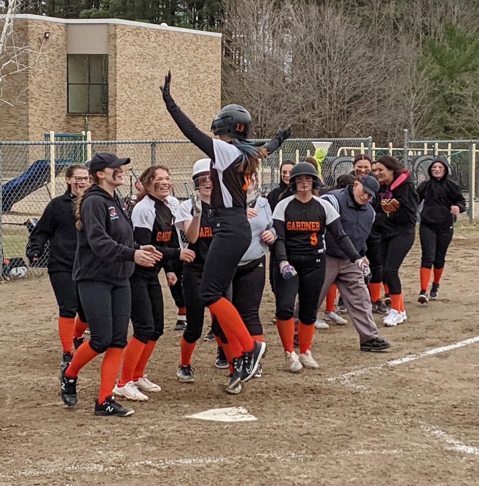 Gardner's Emma McNamara celebrates with her teammates after hitting a three-run home run in the top of the sixth inning of Friday's game against Murdock in Winchendon.